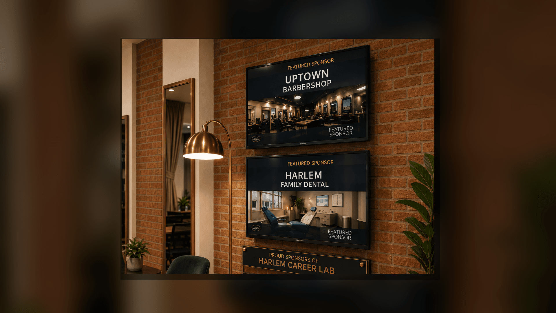 Digital screens on a brick wall displaying advertisements for Uptown Barbershop and Harlem Family Dental.